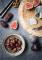 cheese board displayed on a natural slate with figs dates and olives photographed by Amy Murrell