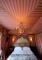 bed and silk detailed ceiling at luxury hotel l'hotel in paris